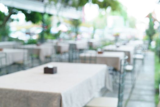 Blur image of cafe or restaurant in day light with bokeh for background.