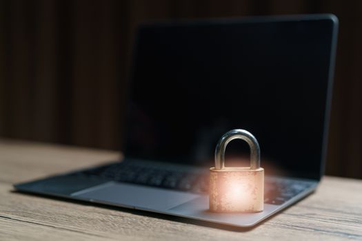 Gold master lock key place on the laptop is concept to lock a datas.