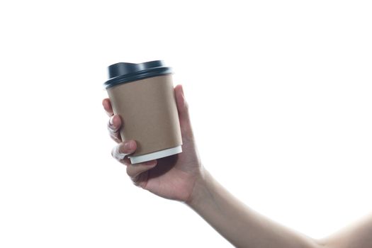 Woman hand holding a brown coffee paper cup isolated on white background.