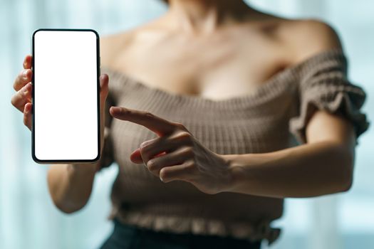 Sexy woman showing white blank display of her mobile phone.