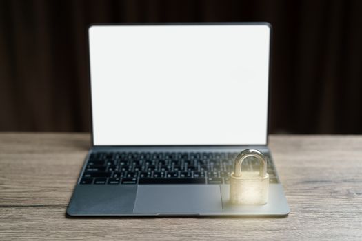 Gold master lock key place on the laptop is concept to lock a datas.