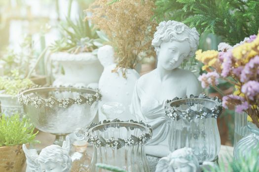 Succulents and home plants in ceramic pots and cement sculpture roman style home decoration.