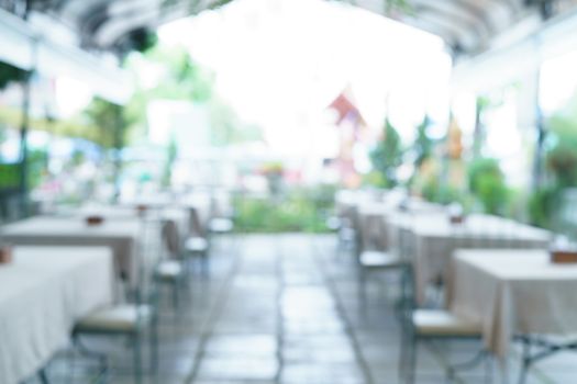 Blur image of cafe or restaurant in day light with bokeh for background.