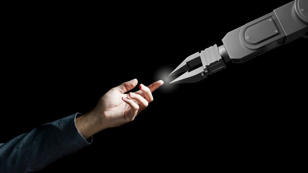 Robot arm and human hand touch like Adam sign isolated on black background. Concept of togetherness