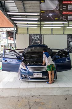 Bangkok, Thailand - January 16, 2016 : Unidentified car care staff cleaning the car (Car detailing).