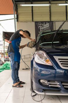 Bangkok, Thailand - January 16, 2016 : Unidentified car care staff cleaning the car (Car detailing).