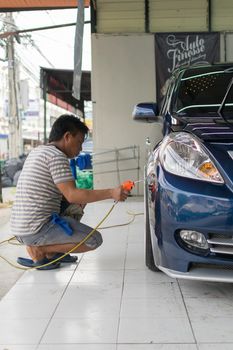 Bangkok, Thailand - January 16, 2016 : Unidentified car care staff cleaning the car (Car detailing).