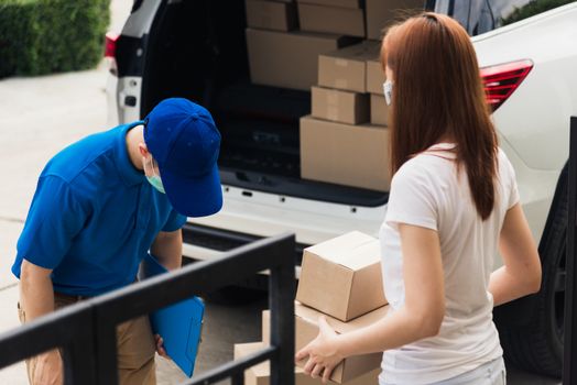 Asian young delivery man head around respect for thanks thank you woman customer use service both protective face mask under curfew quarantine pandemic coronavirus COVID-19 at front home door