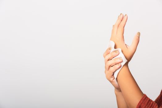 Close up hand of Asian woman she using wet tissue paper wipe cleaning her hands, studio shot isolated on white background, Healthcare medicine body care concept