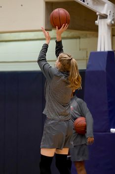 Exciting plays being made by young girls playing basketball