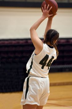 Exciting plays being made by young girls playing basketball