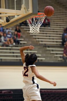 Exciting plays being made by young girls playing basketball