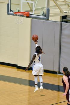 Exciting plays being made by young girls playing basketball