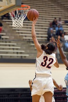 Exciting plays being made by young girls playing basketball