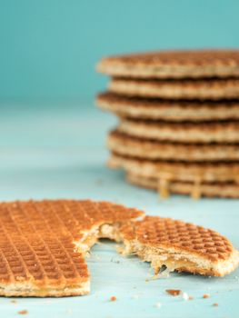 Stroopwafels or caramel Dutch Waffle close up on turquoise wooden background