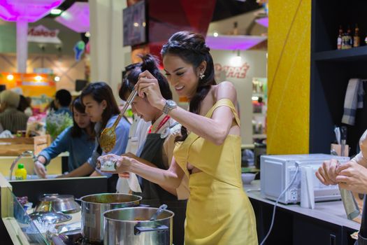 Bangkok, Thailand - May 28, 2016 : Unidentified asia women serving hot curry for tasting in food festival.