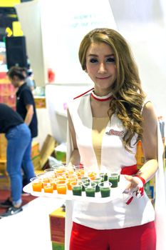 Bangkok, Thailand - May 29, 2016 : Unidentified asia women serving fruit juice drink for tasting in food festival. This a open event no need press credentials required.