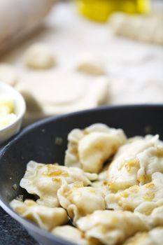 Pierogi fried with potato mash.