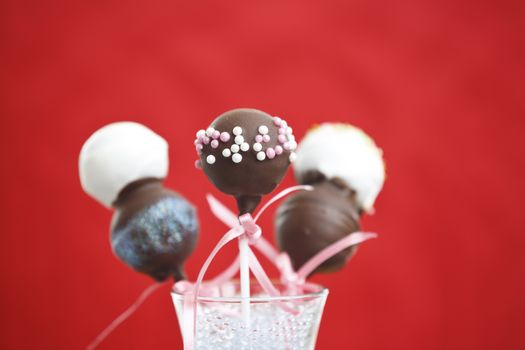 Cakepop over red background.