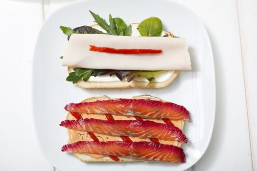 Delicious sandwich with gravlax, turkey and green vegetables.