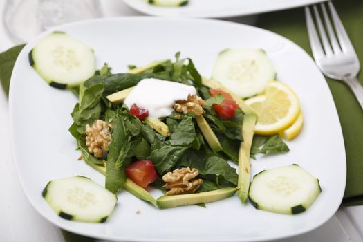 Spinach salad with lox and avocado.