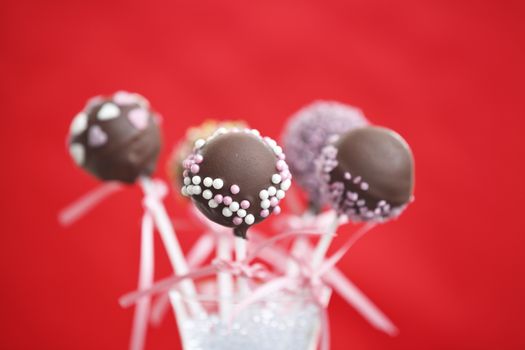 Cakepop over red background.