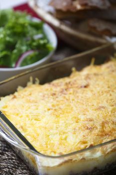 Delicious dish of meat pie with bread and green salad.