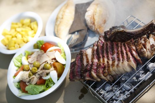 Steak with salad and fries.