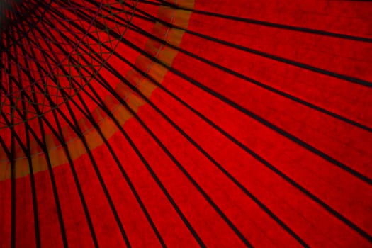 Bottom view of a red parasol in a park in Japan.