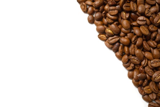Pile of roasted coffee beans isolated in white background