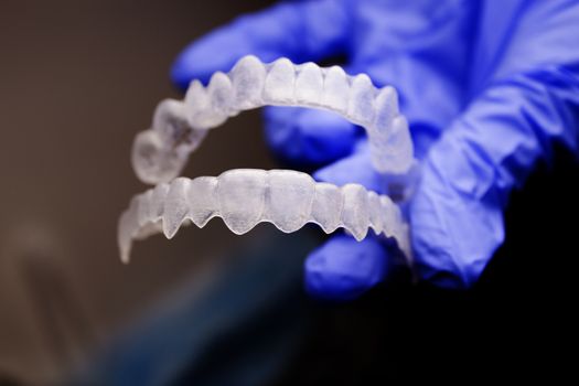 Dentists hand with latex gloves holding a dental orthodontic