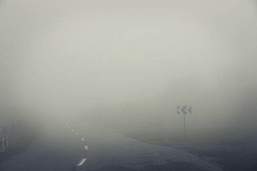 Beautiful mysterious image of the mountain in a foggy day.