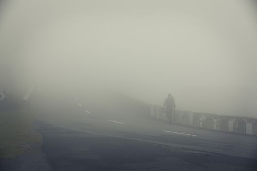 Man walking through the fog in the mountain.