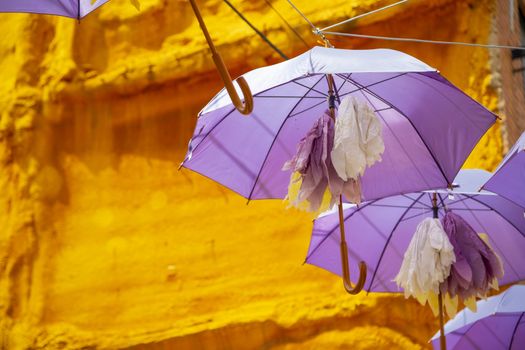 Background of purple umbrellas seen from bottom view in a small city. The very inhabitants were the one creating this art in the street during the Lavender season in a Festival in July. The Festival was held in July the 7th 2019 in a small city called Brihuega, in Guadalajara. SPAIN.