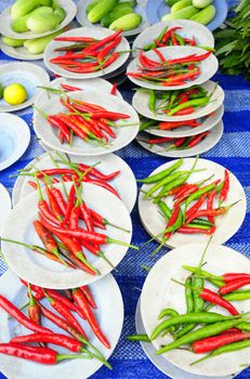Red and green chilies on the plate For sale