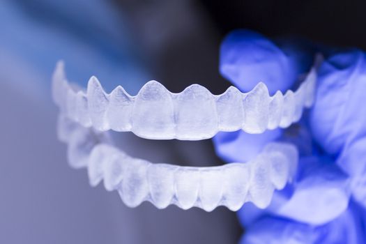 Dentists hand with latex gloves holding a dental orthodontic