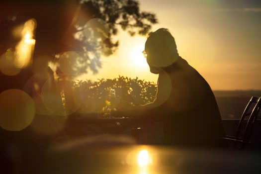 Sunset with the sun against leaving a beautiful silhouette of a man.