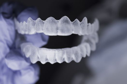 Dentists hand with latex gloves holding a dental orthodontic