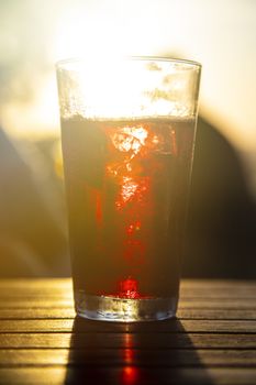 Red wine against the sun with male silhouette at background