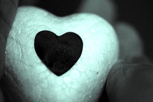 White heart made of polystyrene and bright black heart