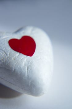 White heart made of polystyrene and bright red heart