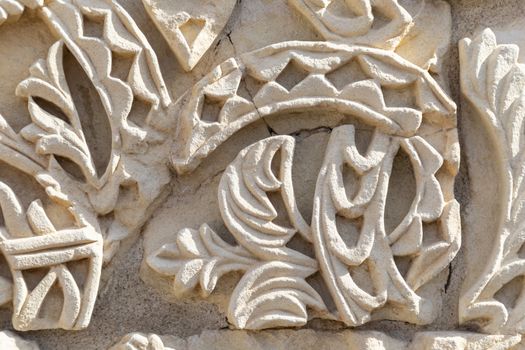 Cordoba, Spain -  November 1 2019: Fragment of wall with floral paterns in 10th century ruined Moorish medieval city Medina Azahara in Andalucia on November 1, 201. UNESCO world heritage site.