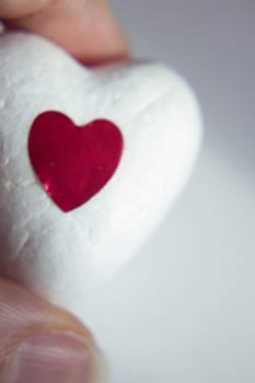 White heart made of polystyrene and bright red heart