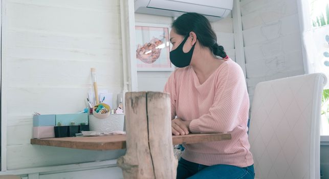 The shopkeeper woman sat in the shop waiting for the customer. Stores affected by the outbreak of the corona virus(COVID-19).