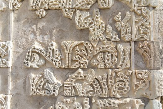 Cordoba, Spain -  November 1 2019: Fragment of wall with floral paterns in 10th century ruined Moorish medieval city Medina Azahara in Andalucia on November 1, 201. UNESCO world heritage site.