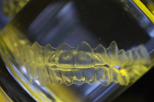 Invisible dental orthodontic submerged in water for cleaning