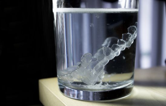 Invisible dental orthodontic submerged in water for cleaning