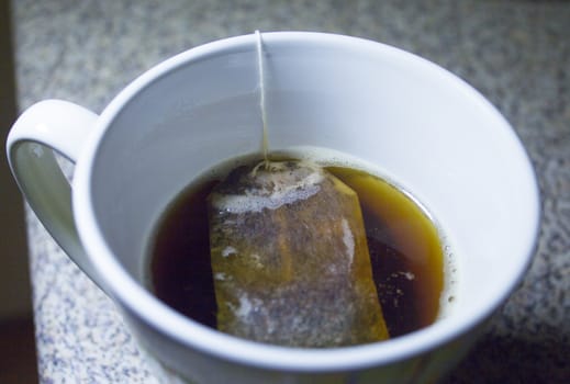 Infusion bag inside a cup with hot water