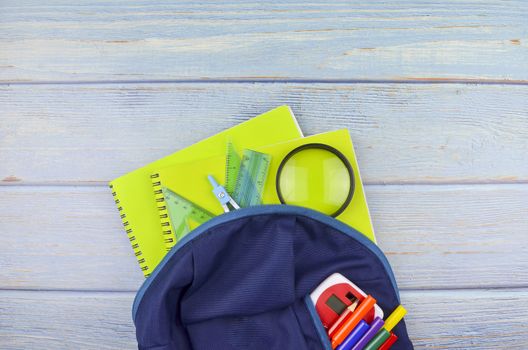 Student backpack and various school supplies, studing, education and back to school concept.