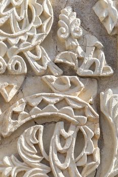 Cordoba, Spain -  November 1 2019: Fragment of wall with floral paterns in 10th century ruined Moorish medieval city Medina Azahara in Andalucia on November 1, 201. UNESCO world heritage site.